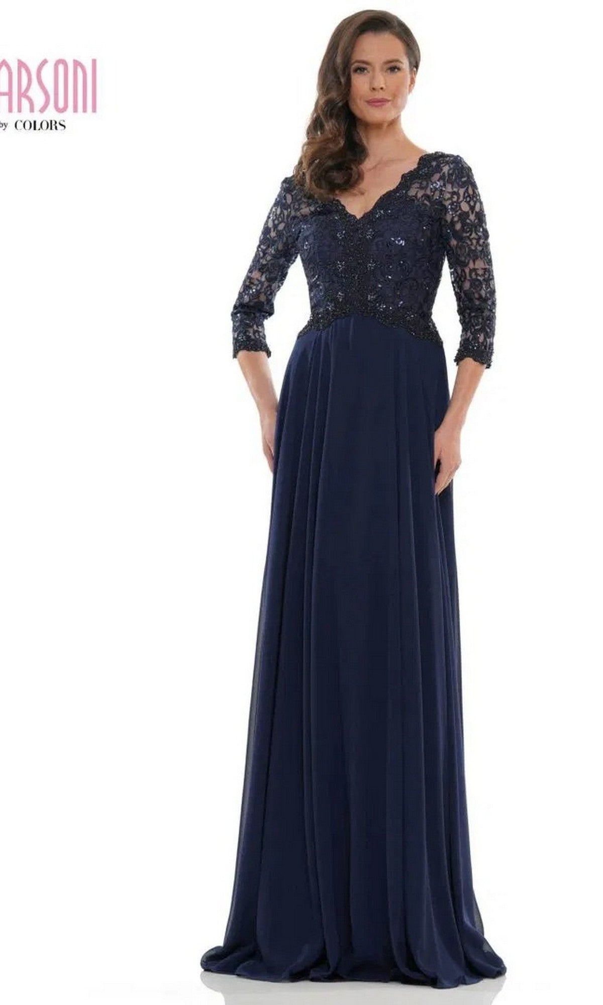 A woman models the Marsoni M225 Long Formal Dress in navy, featuring a lace-embroidered bodice and three-quarter sleeves, against a white background.